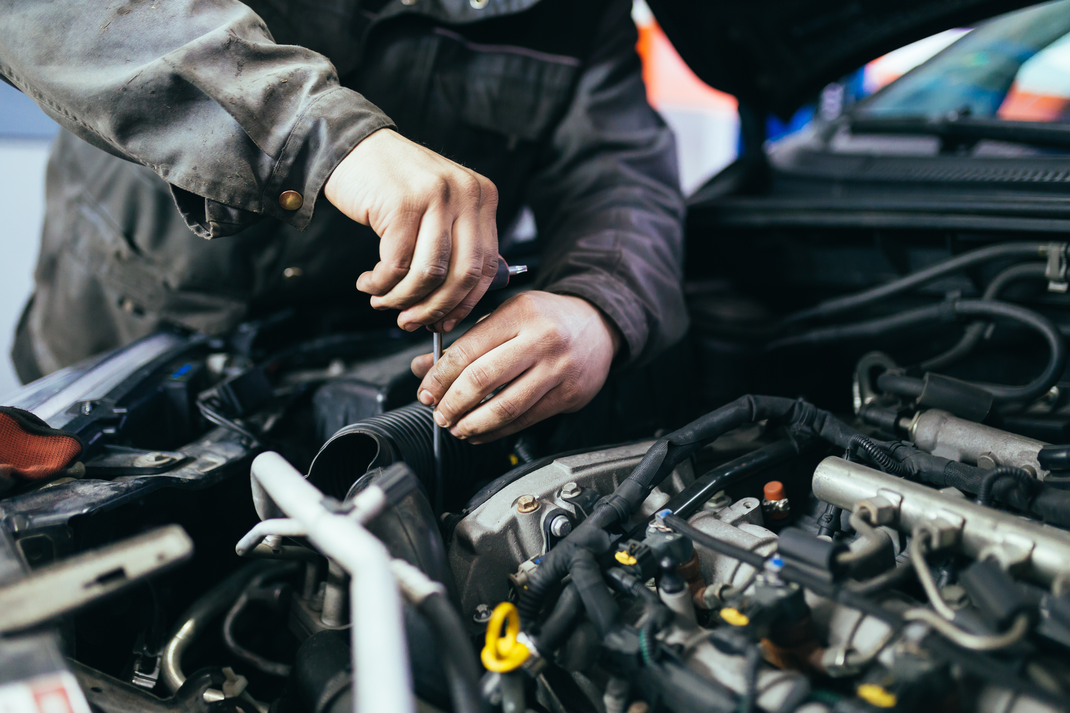 Auto mechanic repairing car. Selective focus.